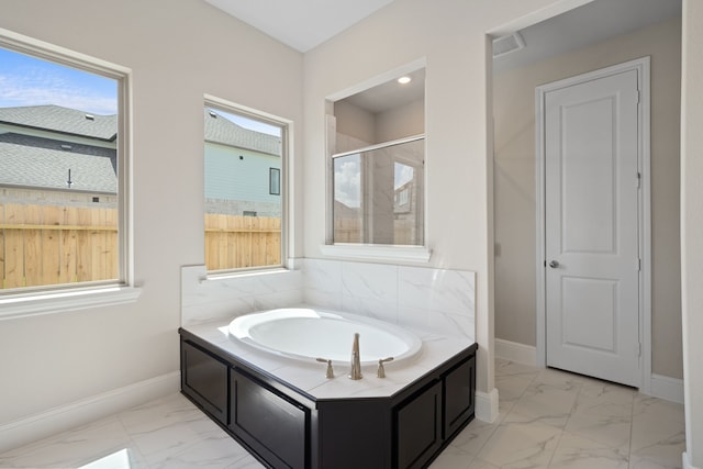 916 Wormwood Dr, League City, TX 77573 - full bath with marble look tile flooring, a bath, and tiled shower