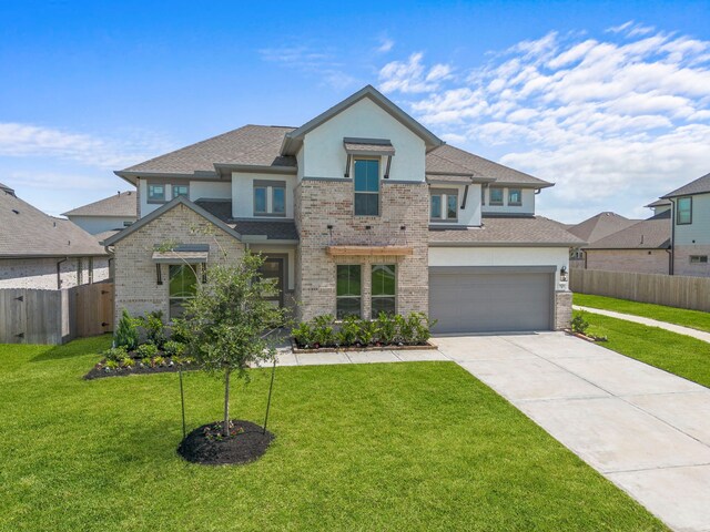916 Wormwood Dr, League City, TX 77573 - view of front of home featuring concrete driveway, stucco siding, brick siding, a garage, and roof with shingles