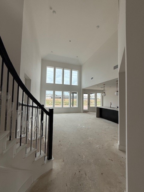 1439 Watermont Dr, Missouri City, TX 77459 - unfurnished living room with a towering ceiling and stairway