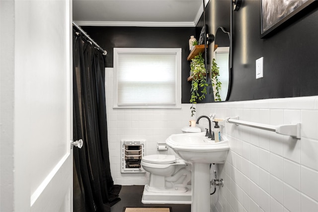 208 W 34th St, Houston, TX 77018 - bathroom with heating unit, tile walls, curtained shower, ornamental molding, and a wainscoted wall