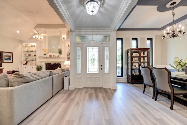 1950 Country Club Rd, Brenham, TX 77833 - entrance foyer with a chandelier, crown molding, light wood-style flooring, a fireplace, and ceiling fan