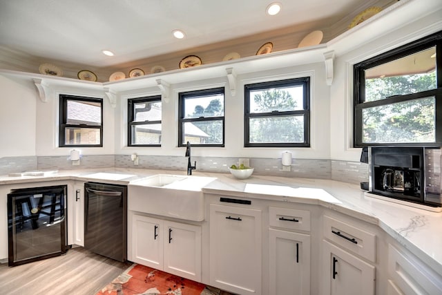 1950 Country Club Rd, Brenham, TX 77833 - kitchen with dishwashing machine, wine cooler, plenty of natural light, white cabinetry, and recessed lighting