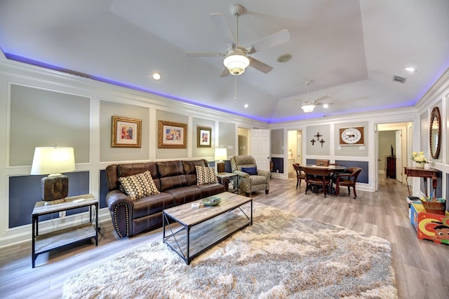1950 Country Club Rd, Brenham, TX 77833 - living area with a ceiling fan, lofted ceiling, wood finished floors, ornamental molding, and a decorative wall