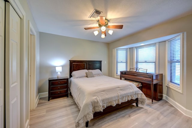 1950 Country Club Rd, Brenham, TX 77833 - bedroom with light wood-style flooring, a ceiling fan, and a closet