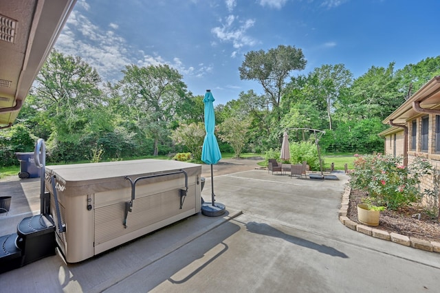 1950 Country Club Rd, Brenham, TX 77833 - view of patio / terrace featuring a hot tub and view of scattered trees