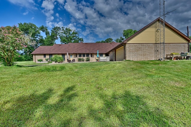 1950 Country Club Rd, Brenham, TX 77833 - back of property with brick siding, an attached garage, and a lawn