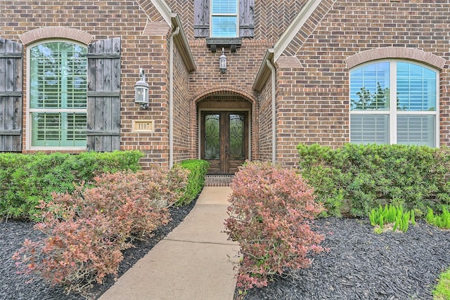 1107 Rymers Switch Ln, Friendswood, TX 77546 - view of exterior entry featuring french doors and brick siding