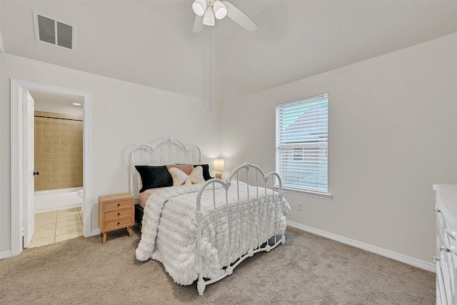 1107 Rymers Switch Ln, Friendswood, TX 77546 - bedroom featuring light carpet, vaulted ceiling, a ceiling fan, and ensuite bath