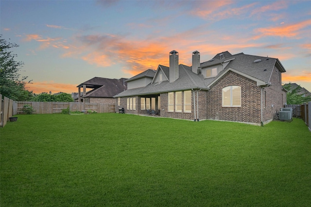 1107 Rymers Switch Ln, Friendswood, TX 77546 - back of property with brick siding, a chimney, a fenced backyard, and roof with shingles
