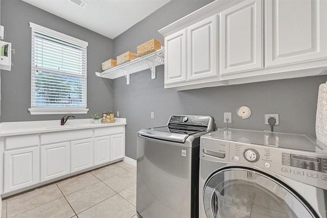 1107 Rymers Switch Ln, Friendswood, TX 77546 - washroom with independent washer and dryer, cabinet space, and light tile patterned floors