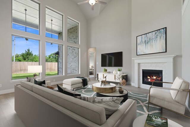 910 Hooks Trl, League City, TX 77573 - living room with a tile fireplace, high vaulted ceiling, wood finished floors, and ceiling fan