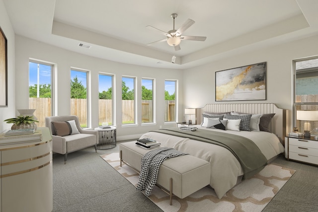 910 Hooks Trl, League City, TX 77573 - carpeted bedroom featuring a raised ceiling, multiple windows, and ceiling fan