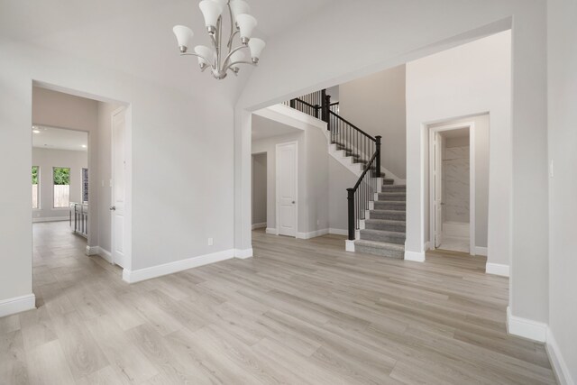 910 Hooks Trl, League City, TX 77573 - entryway featuring stairway, light wood finished floors, and a chandelier