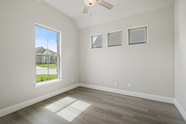 910 Hooks Trl, League City, TX 77573 - unfurnished room featuring healthy amount of natural light, wood finished floors, a ceiling fan, and lofted ceiling