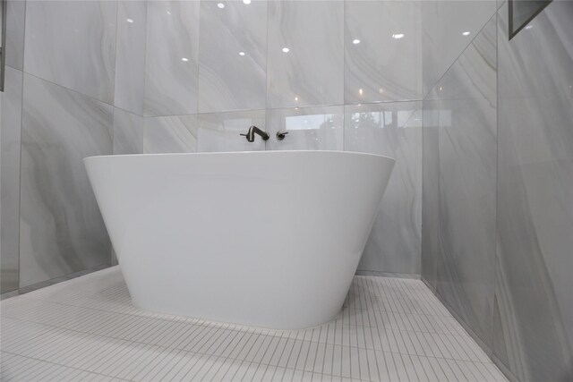 510 E 37th St, Houston, TX 77022 - full bathroom featuring tile walls, tile patterned floors, and a soaking tub