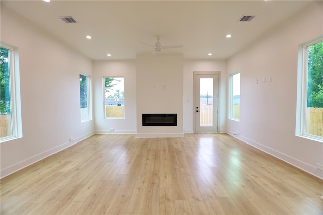510 E 37th St, Houston, TX 77022 - unfurnished living room with light wood-style floors, ceiling fan, a glass covered fireplace, and recessed lighting