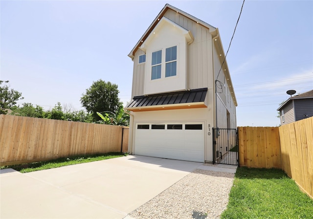 510 E 37th St, Houston, TX 77022 - view of front of property with a standing seam roof, an attached garage, concrete driveway, a gate, and a metal roof