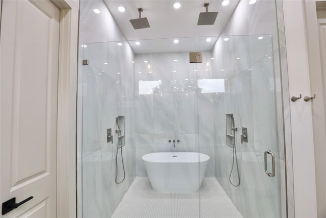 510 E 37th St, Houston, TX 77022 - full bathroom featuring a marble finish shower, recessed lighting, tile walls, a soaking tub, and tile patterned flooring
