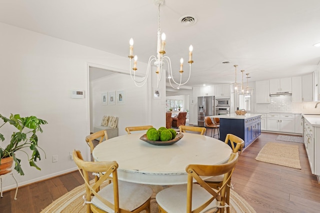 3006 Ann Arbor Dr, Houston, TX 77063 - dining space with a chandelier and wood-type flooring