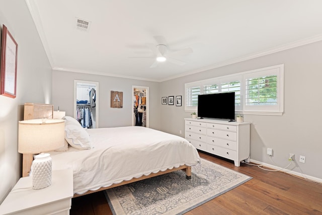 3006 Ann Arbor Dr, Houston, TX 77063 - bedroom featuring ornamental molding, wood finished floors, a spacious closet, and a ceiling fan