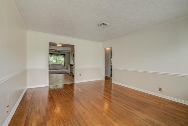 211 Magnolia St, Lake Jackson, TX 77566 - spare room featuring hardwood / wood-style floors and a textured ceiling