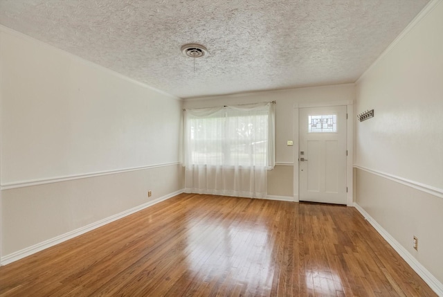 211 Magnolia St, Lake Jackson, TX 77566 - entrance foyer with hardwood / wood-style floors and a textured ceiling