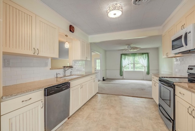 211 Magnolia St, Lake Jackson, TX 77566 - kitchen featuring stainless steel appliances, ornamental molding, ceiling fan, light colored carpet, and backsplash