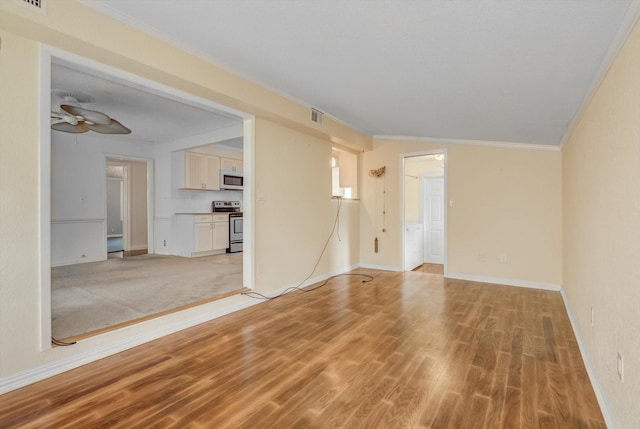 211 Magnolia St, Lake Jackson, TX 77566 - unfurnished living room with ornamental molding, light wood-type flooring, and ceiling fan