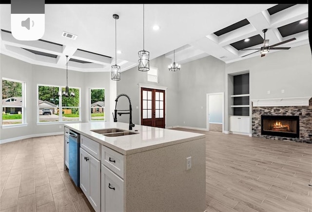 427 Rd 66111, Dayton, TX 77535 - kitchen with coffered ceiling, a ceiling fan, a fireplace, open floor plan, and pendant lighting