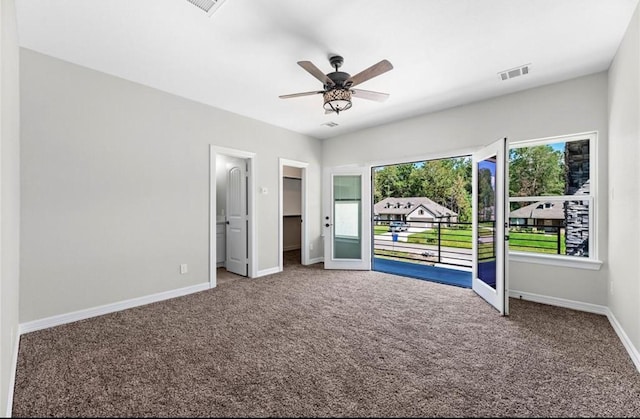 427 Rd 66111, Dayton, TX 77535 - unfurnished bedroom featuring carpet floors, a walk in closet, and a ceiling fan