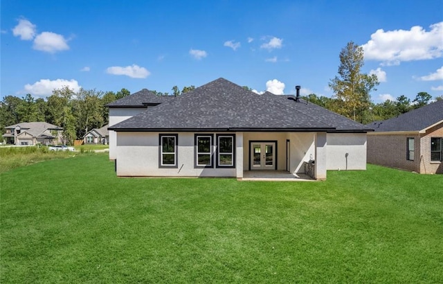 427 Rd 66111, Dayton, TX 77535 - rear view of house with french doors, a shingled roof, a yard, and stucco siding