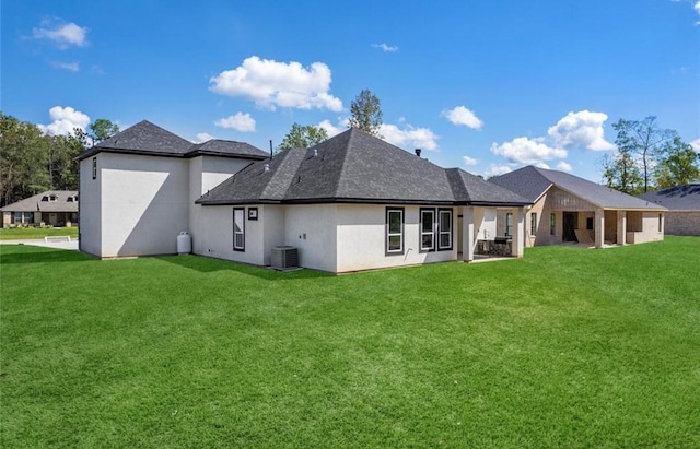 427 Rd 66111, Dayton, TX 77535 - back of property with stucco siding, a yard, and roof with shingles