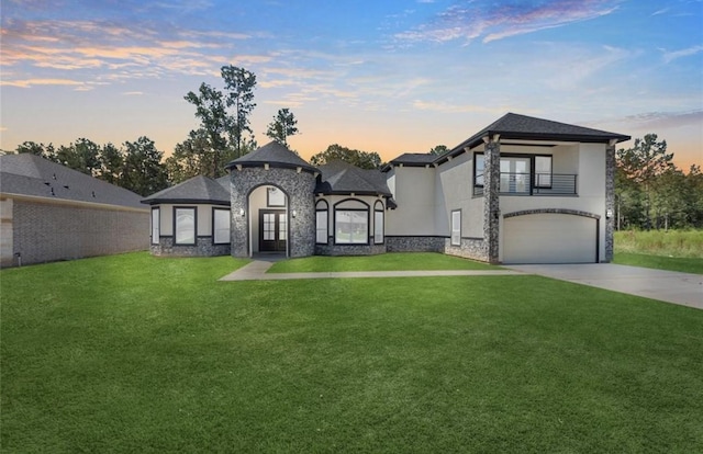 427 Rd 66111, Dayton, TX 77535 - view of front of home with a balcony, a lawn, a garage, and stucco siding
