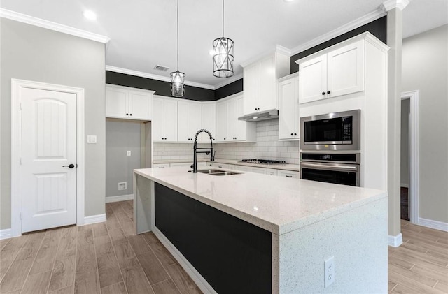 427 Rd 66111, Dayton, TX 77535 - kitchen featuring stainless steel appliances, tasteful backsplash, ornamental molding, light stone countertops, and light wood-style flooring