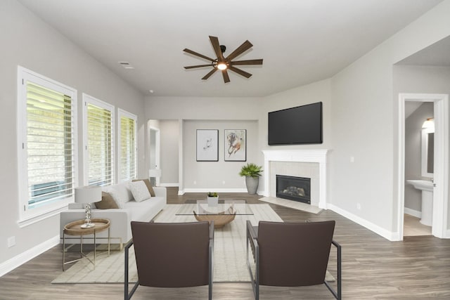 1831 Golden Cape Dr, Katy, TX 77494 - living area featuring a ceiling fan, healthy amount of natural light, a tile fireplace, and wood finished floors