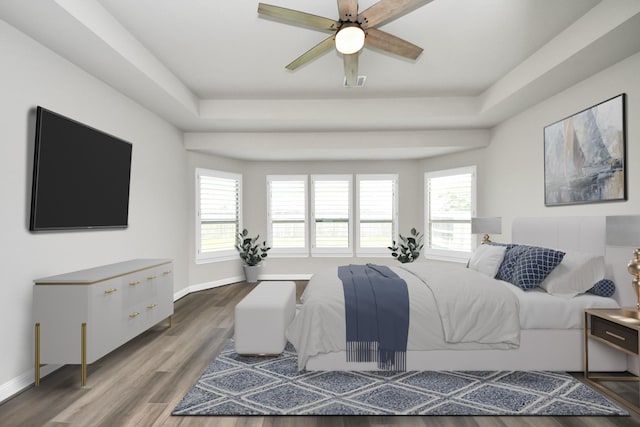 1831 Golden Cape Dr, Katy, TX 77494 - bedroom featuring wood finished floors, a tray ceiling, and a ceiling fan