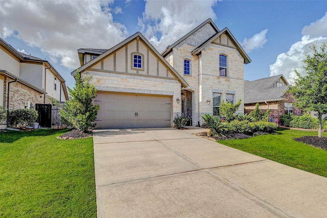28638 Monarch Cliffs Dr, Fulshear, TX 77441 - view of front of house with stone siding, driveway, a front yard, and stucco siding