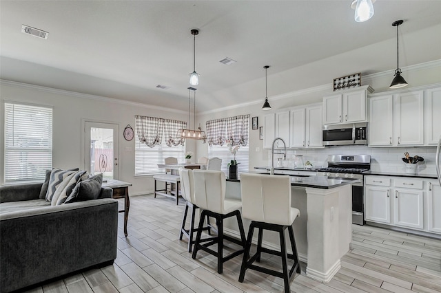 28638 Monarch Cliffs Dr, Fulshear, TX 77441 - kitchen featuring stainless steel appliances, dark countertops, crown molding, tasteful backsplash, and open floor plan