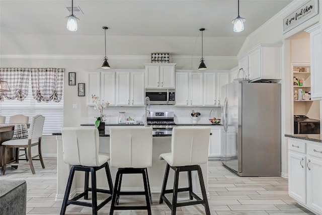 28638 Monarch Cliffs Dr, Fulshear, TX 77441 - kitchen with stainless steel appliances, decorative backsplash, ornamental molding, and white cabinetry