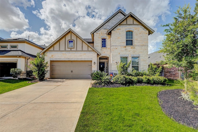 28638 Monarch Cliffs Dr, Fulshear, TX 77441 - view of front of home featuring stone siding, driveway, a front yard, and a garage