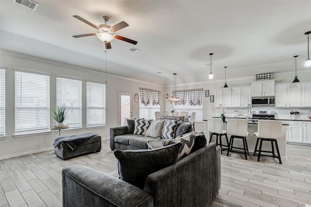 28638 Monarch Cliffs Dr, Fulshear, TX 77441 - living room featuring ceiling fan, ornamental molding, and wood tiled floors