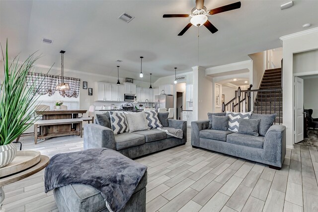 28638 Monarch Cliffs Dr, Fulshear, TX 77441 - living room featuring ceiling fan, stairs, and ornamental molding