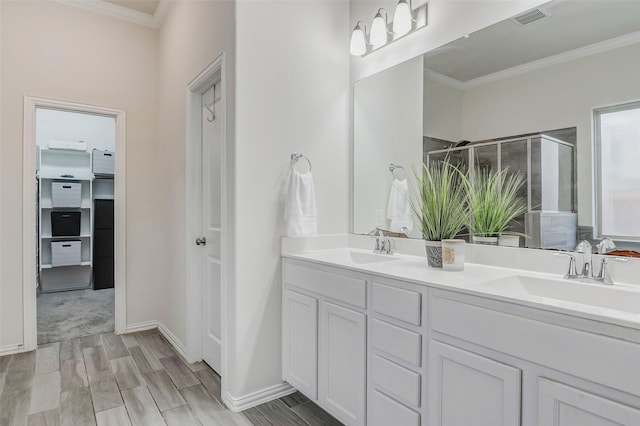 28638 Monarch Cliffs Dr, Fulshear, TX 77441 - full bathroom featuring ornamental molding, a stall shower, double vanity, and wood finished floors