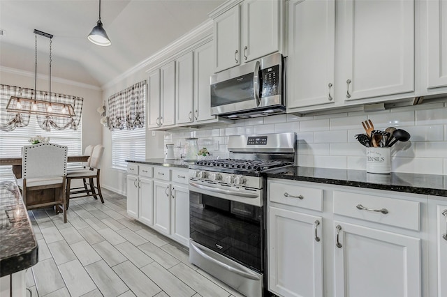 28638 Monarch Cliffs Dr, Fulshear, TX 77441 - kitchen featuring stainless steel appliances, crown molding, backsplash, white cabinets, and a chandelier