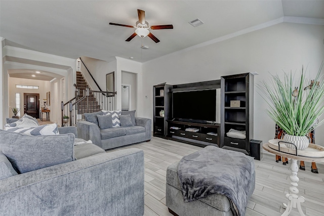 28638 Monarch Cliffs Dr, Fulshear, TX 77441 - living room with a ceiling fan, stairway, arched walkways, crown molding, and light wood-type flooring