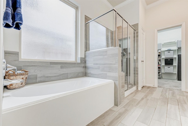 28638 Monarch Cliffs Dr, Fulshear, TX 77441 - full bathroom featuring ornamental molding, a garden tub, a stall shower, and wood finished floors
