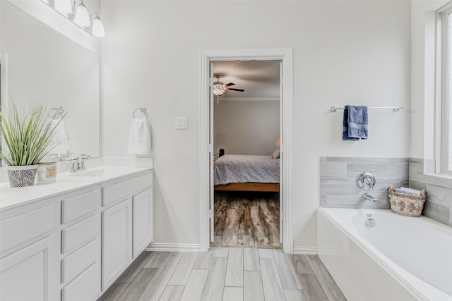 28638 Monarch Cliffs Dr, Fulshear, TX 77441 - ensuite bathroom with vanity, a bath, a ceiling fan, and wood finished floors