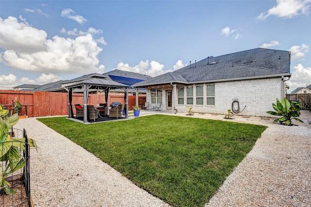 28638 Monarch Cliffs Dr, Fulshear, TX 77441 - rear view of property with a shingled roof, a gazebo, a patio area, a fenced backyard, and brick siding