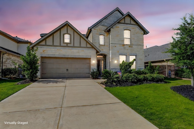 28638 Monarch Cliffs Dr, Fulshear, TX 77441 - view of front of property with stone siding, concrete driveway, a yard, and a garage