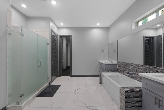 5215 Kelso St, Houston, TX 77021 - bathroom with two vanities, a shower stall, a jetted tub, marble look tiles, and recessed lighting